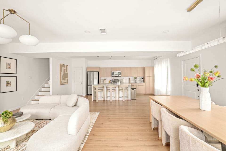 Airy open-plan living and dining area featuring contemporary decor, cozy seating
