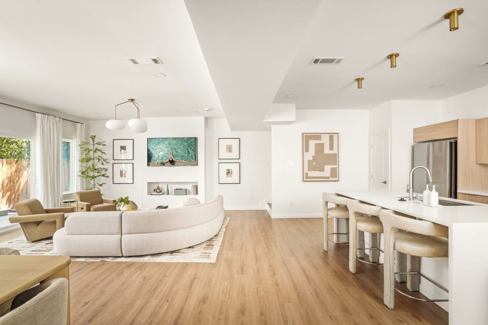 Bright open-concept living and dining area with modern decor, cozy seating.