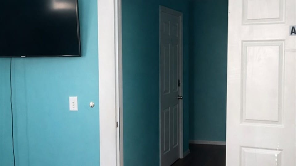 Wall-mounted TV and hallway access