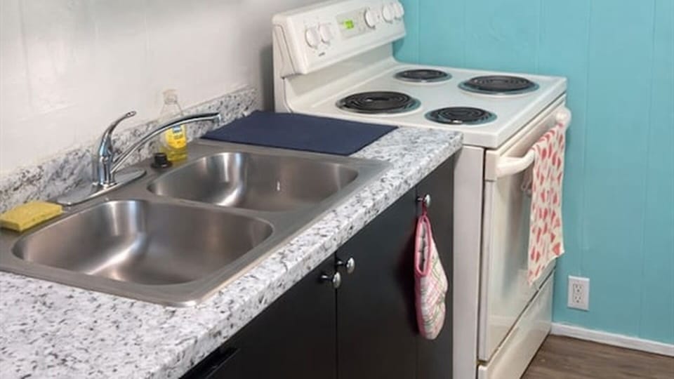 Kitchen with sink, stove, and counter space