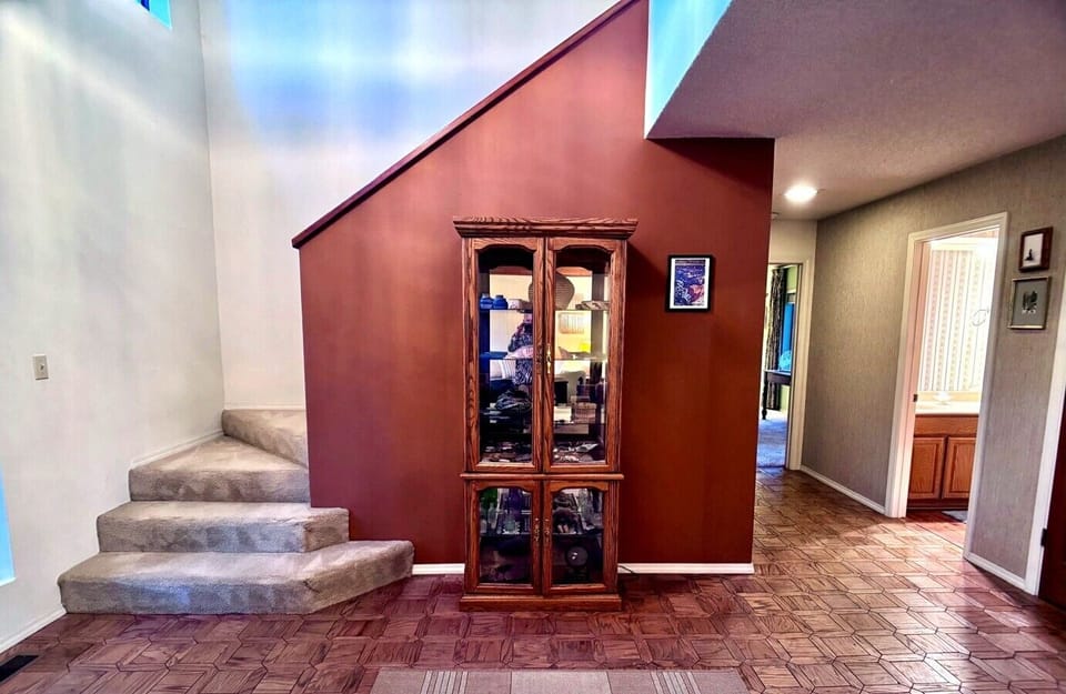 Warm interior landing with stair access and classic cabin character.