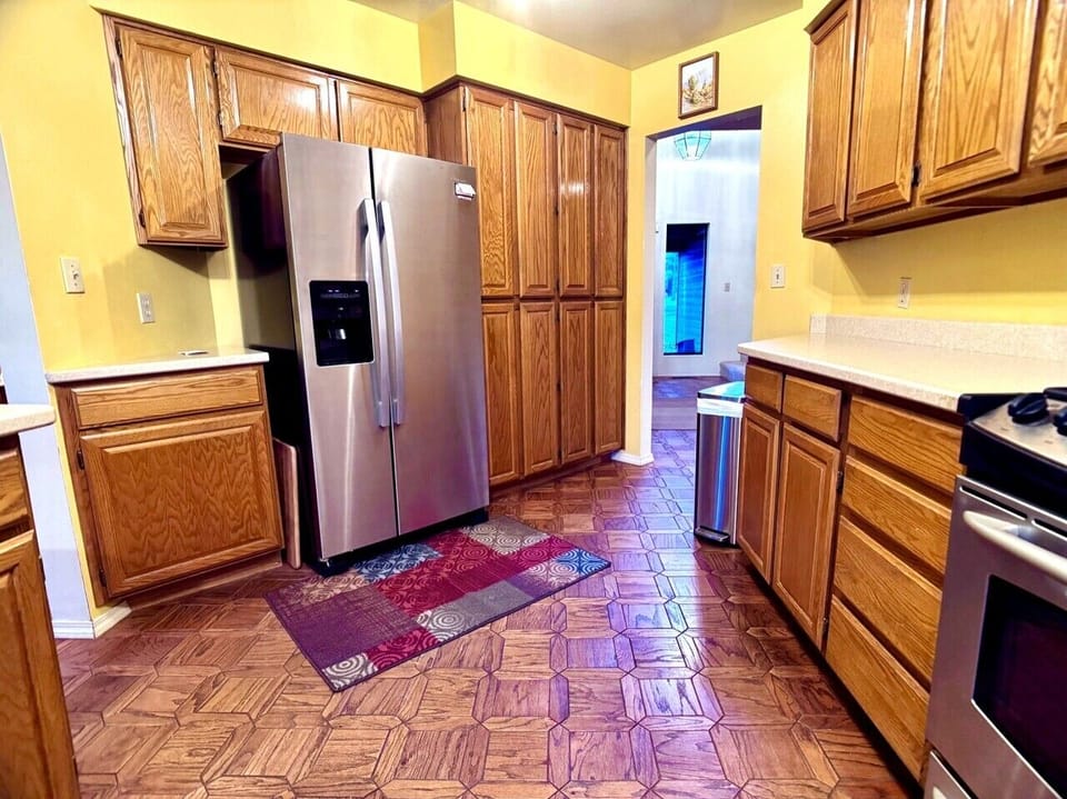 Kitchen storage, stainless refrigerator, and practical layout for longer stays.