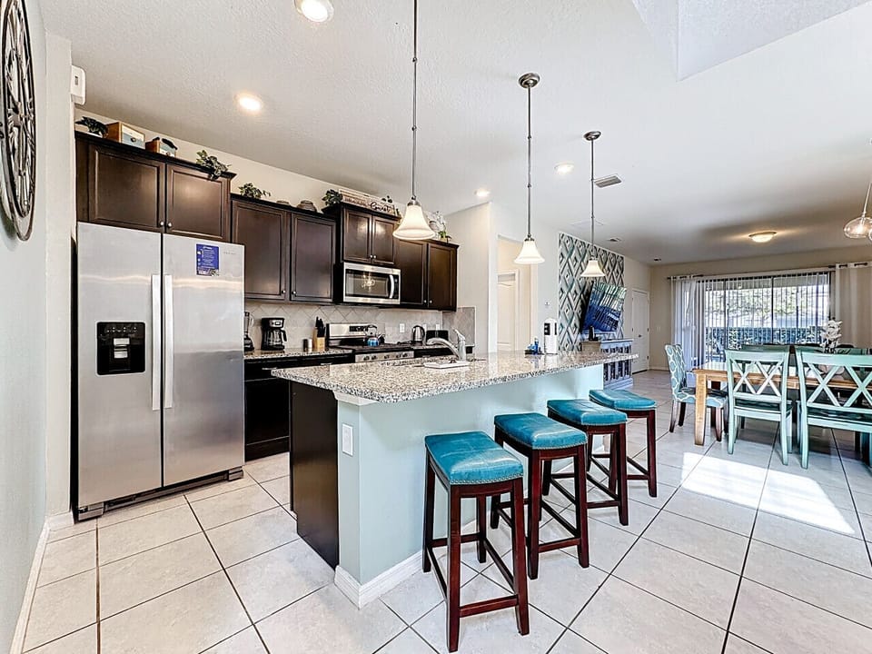 Cook with ease in the fully equipped modern kitchen featuring stainless steel appliances, plenty of counter space, and everything you need for family favorites or quick snacks