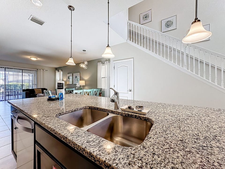 Cook with ease in the fully equipped modern kitchen featuring stainless steel appliances, plenty of counter space, and everything you need for family favorites or quick snacks