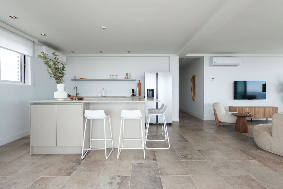 Coastal cooking never looked this good—sleek kitchen, ocean breeze, and a view that makes morning coffee feel extra special.