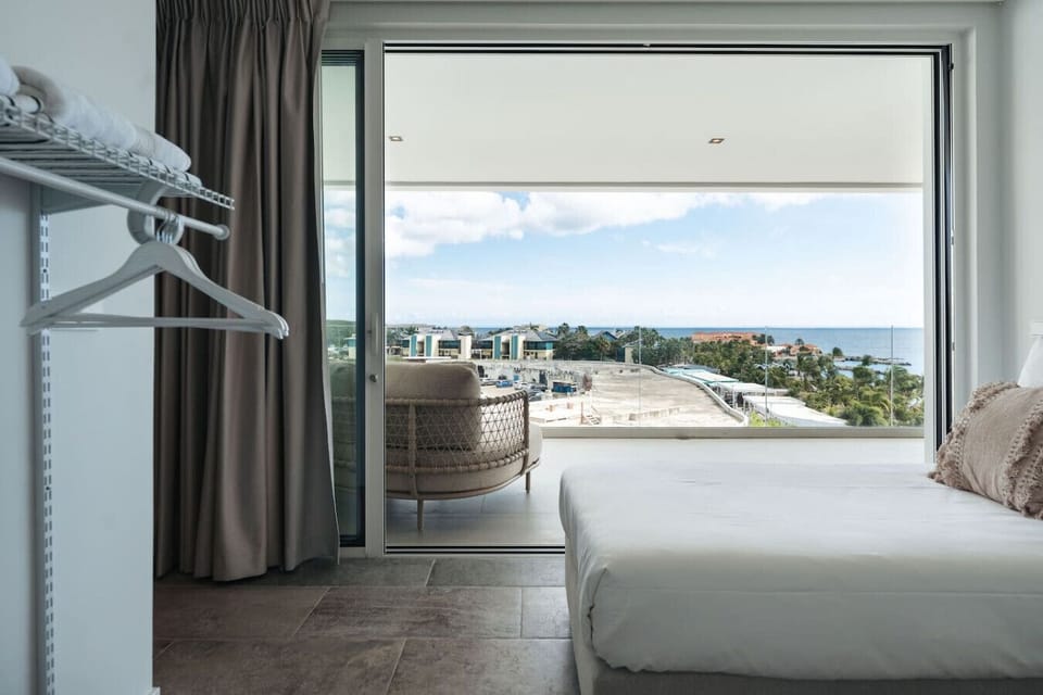 Second Bedroom | The second bedroom features two twin size beds, and a bathroom with private vanity & shower, with a separate toilet in the hallway, ensuring a comfortable and relaxing stay for all guests.