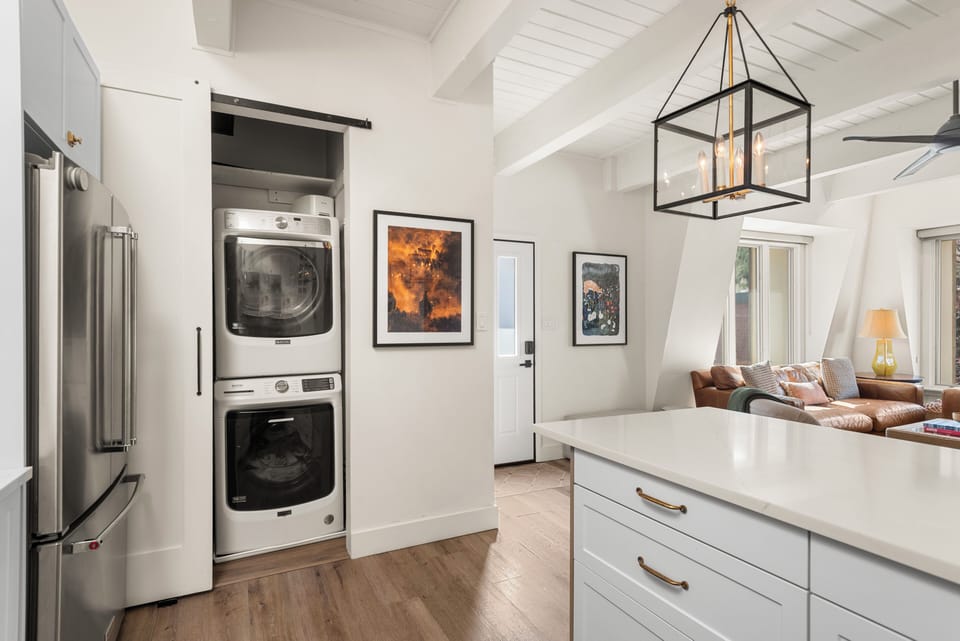 Open-concept and light-filled kitchen, living, dining area with in-unit laundry.