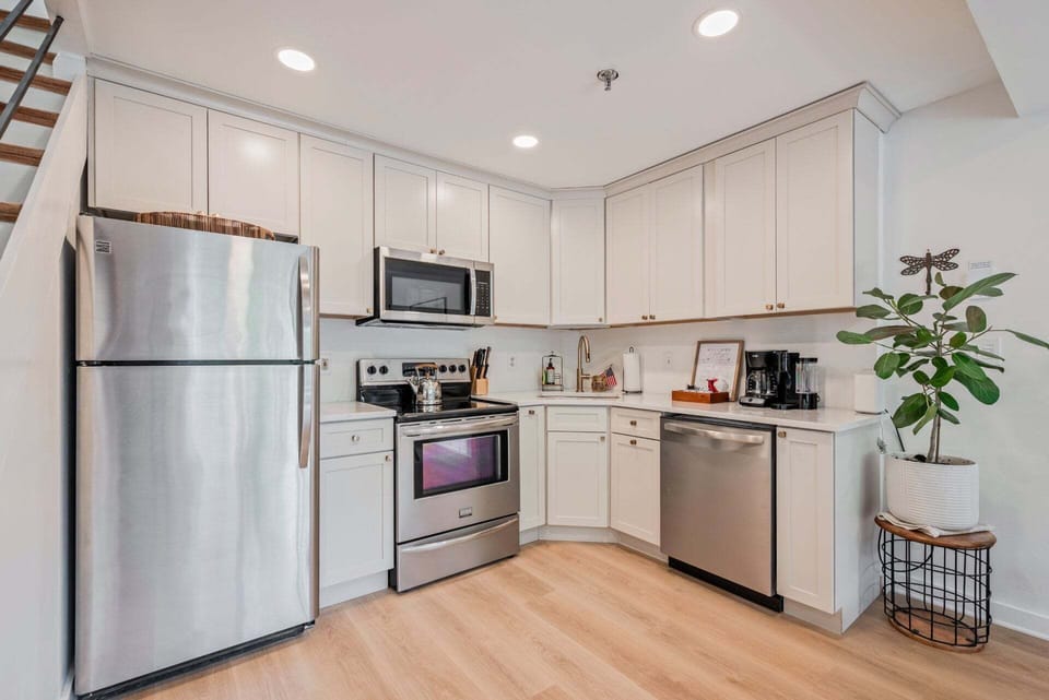 White cabinetry, stainless appliances, and clear counters keep cooking simple between mountain outings.