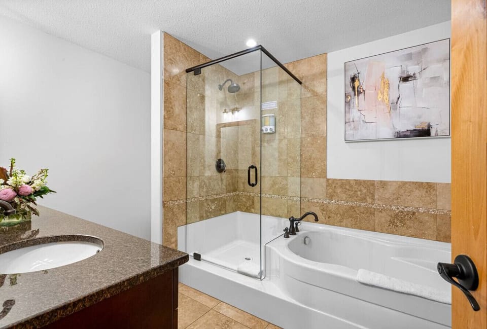 Spacious bathroom with bathtub and shower.