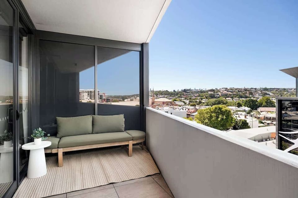 Private balcony off the living space. Adjustable day bed, perfect for relaxing or reading. 8th floor outlook where you can see the NEX, and the ANZAC bridge in the distance.