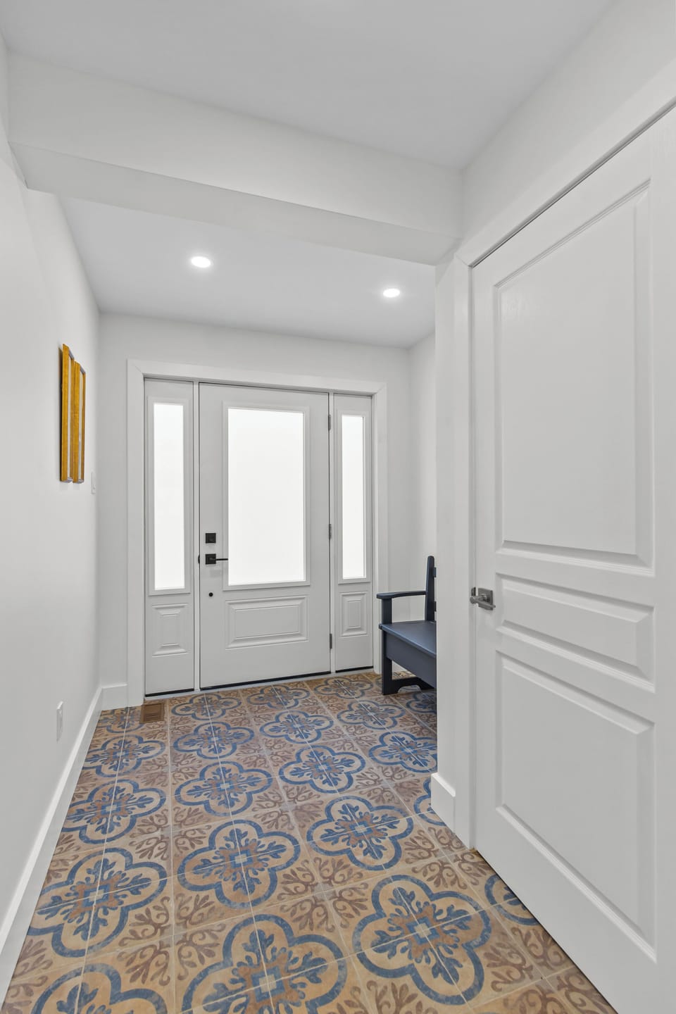 Elegant hallway leading to the front entrance with bright white finishes. A warm welcome every time you return.
