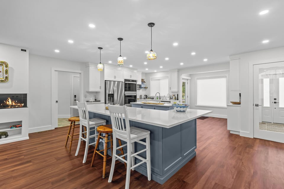 A closer look at our kitchen, highlighting the breakfast bar with seating, ideal for casual meals and morning coffee.
