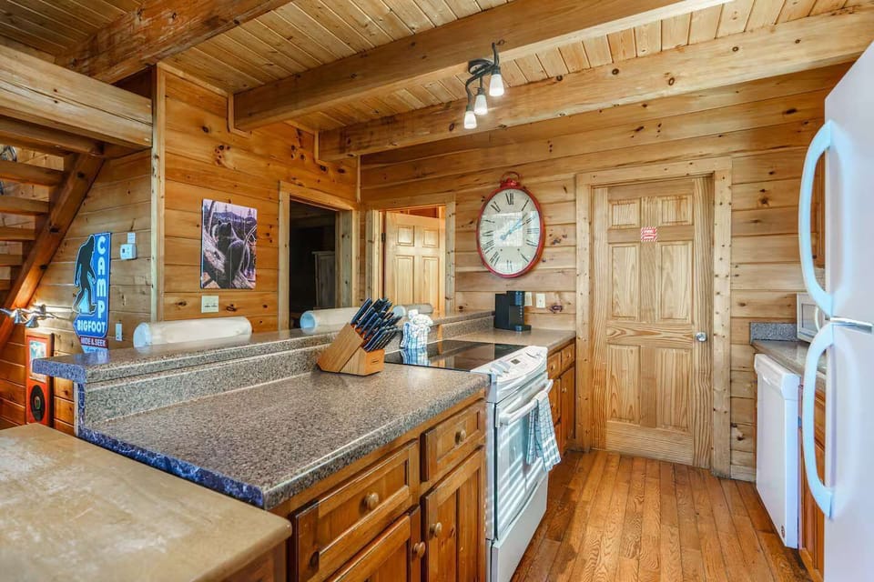 Cook up a feast in this delightful wood-paneled kitchen, featuring modern appliances and stylish details!