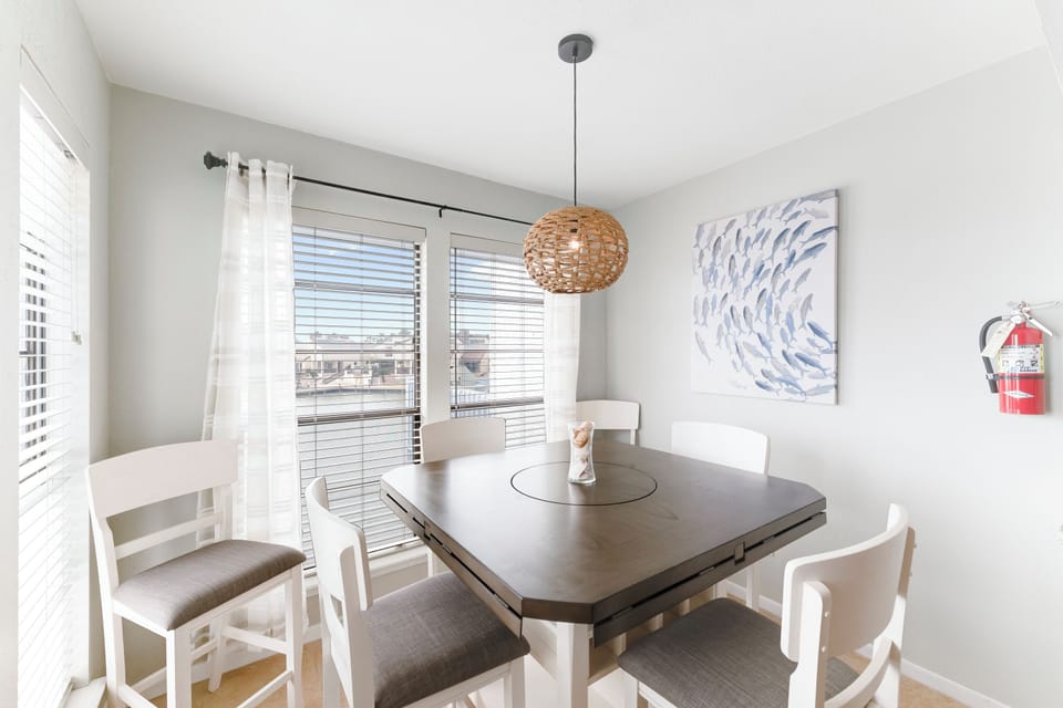 Gather around your stylish dining table where natural light streams through large windows, creating the perfect setting for memorable meals together.