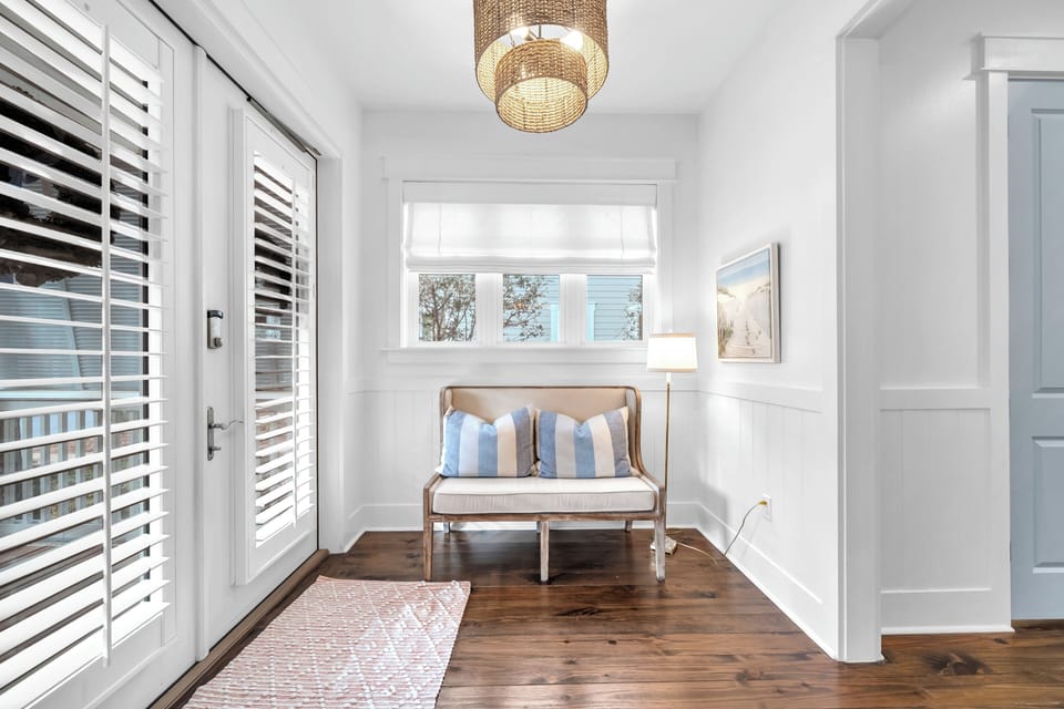 Your modern entryway where warm wood floors meet crisp white walls and coastal charm welcomes you home.