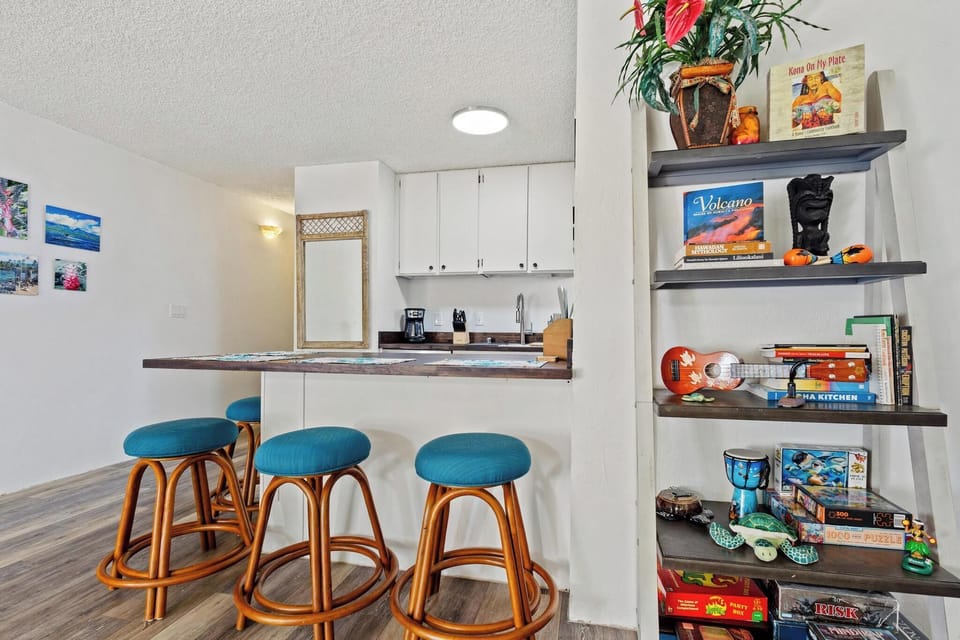 Pull up a seat at your breakfast bar and start your day with island vibes all around—vibrant décor, fresh tropical touches, and a bright, welcoming kitchen ready for your morning coffee.