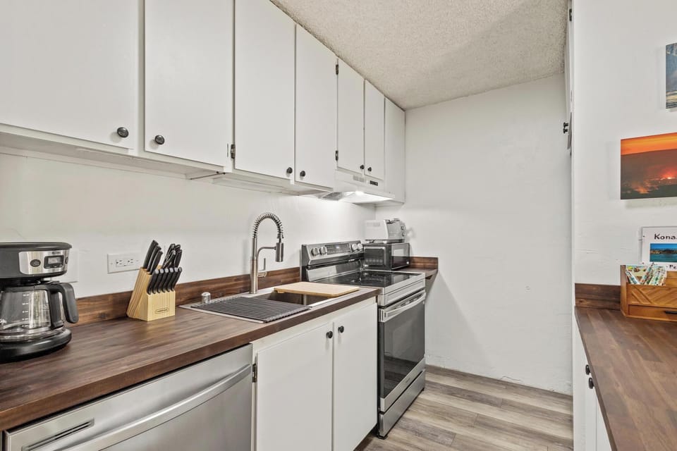 Your fully equipped kitchen has everything you need to prepare meals at home, with modern appliances, ample counter space, and warm wood-tone surfaces for a welcoming feel.
