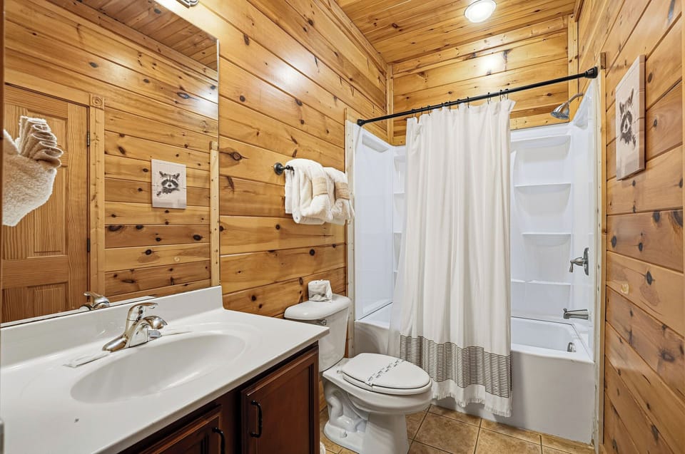 Step into your rustic bathroom with warm wood walls, crisp linens, and everything you need to refresh after mountain adventures.