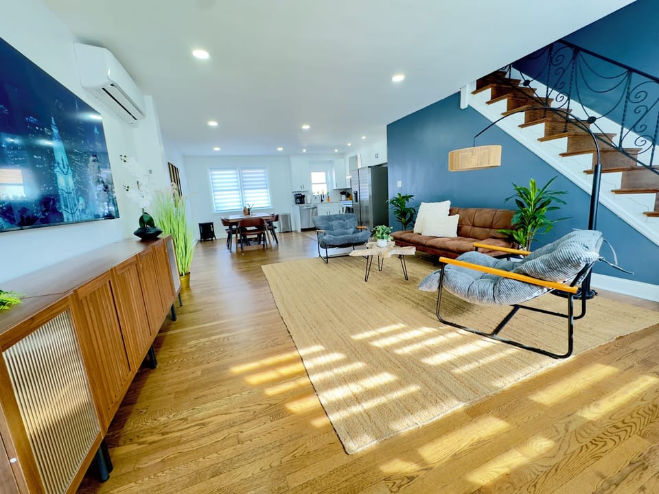Comfortable living room with plush seating, 75" Smart TV, and fast Wifi.
