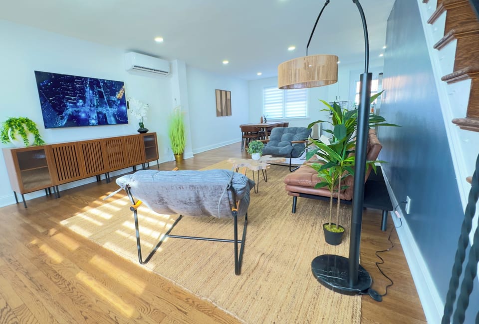 Comfortable living room with plush seating, 75" Smart TV, and fast Wifi.
