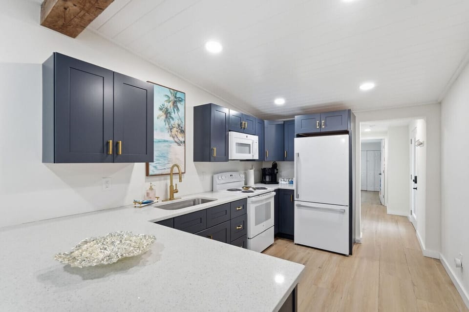 The kitchen is centrally located in the home, offering clear sightlines to the living and dining areas so you can stay connected while cooking. It features ample cabinet space, an oven, refrigerator, microwave, and sink, and is fully equipped with everyth