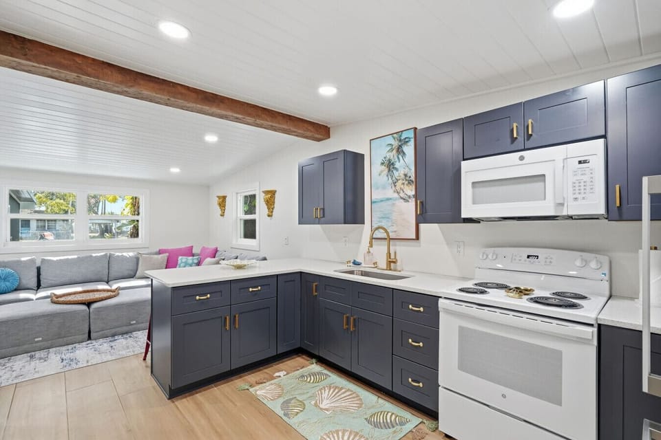 The kitchen is centrally located in the home, offering clear sightlines to the living and dining areas so you can stay connected while cooking. It features ample cabinet space, an oven, refrigerator, microwave, and sink, and is fully equipped with everyth
