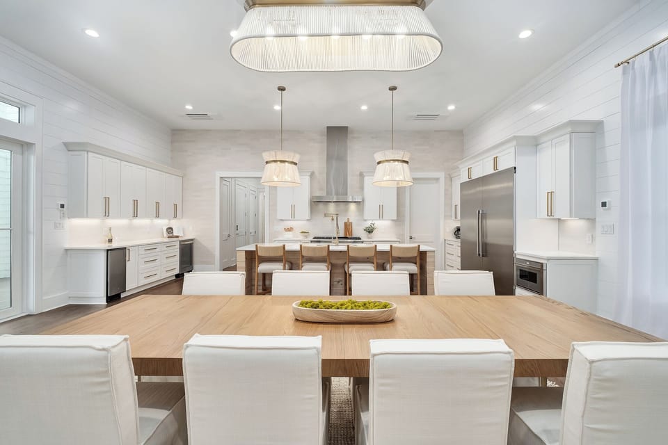 Gather around this stunning dining table where elegant pendant lights create perfect ambiance for your memorable meals together.