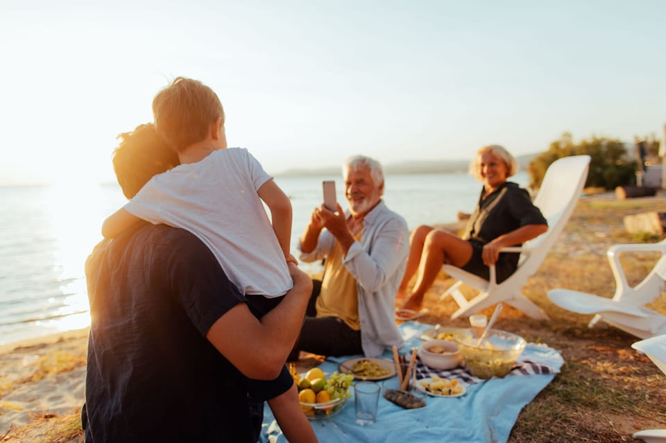 Sunset gatherings by the water capture the laid-back Breton spirit that defines holidays at Camping du Menhir.
