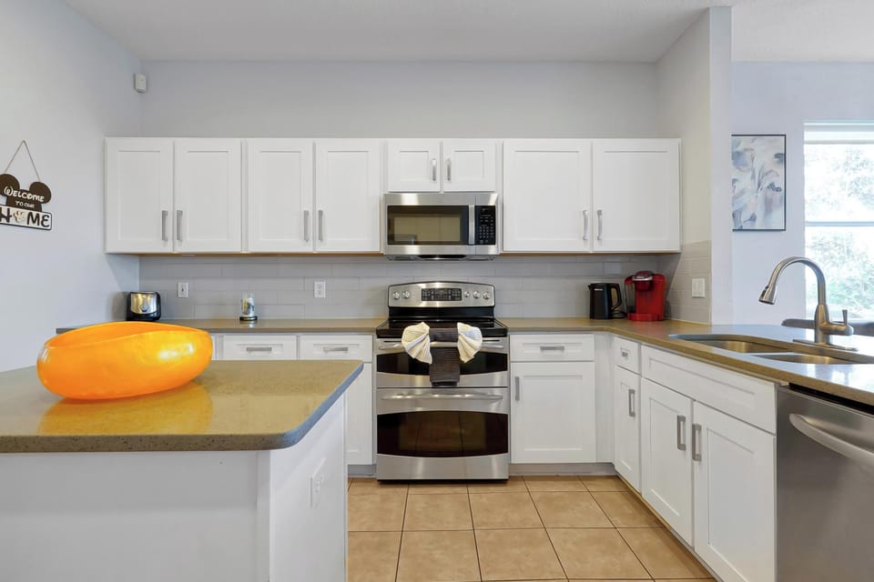 The beautifully updated kitchen features updated white cabinets complimented by durable quartz countertops, 











