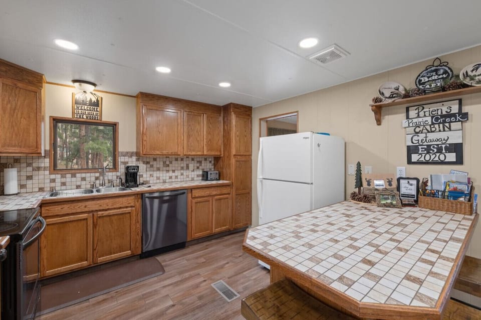 This thoughtfully designed space includes a white refrigerator, microwave, and oven—perfect for home-cooked meals.