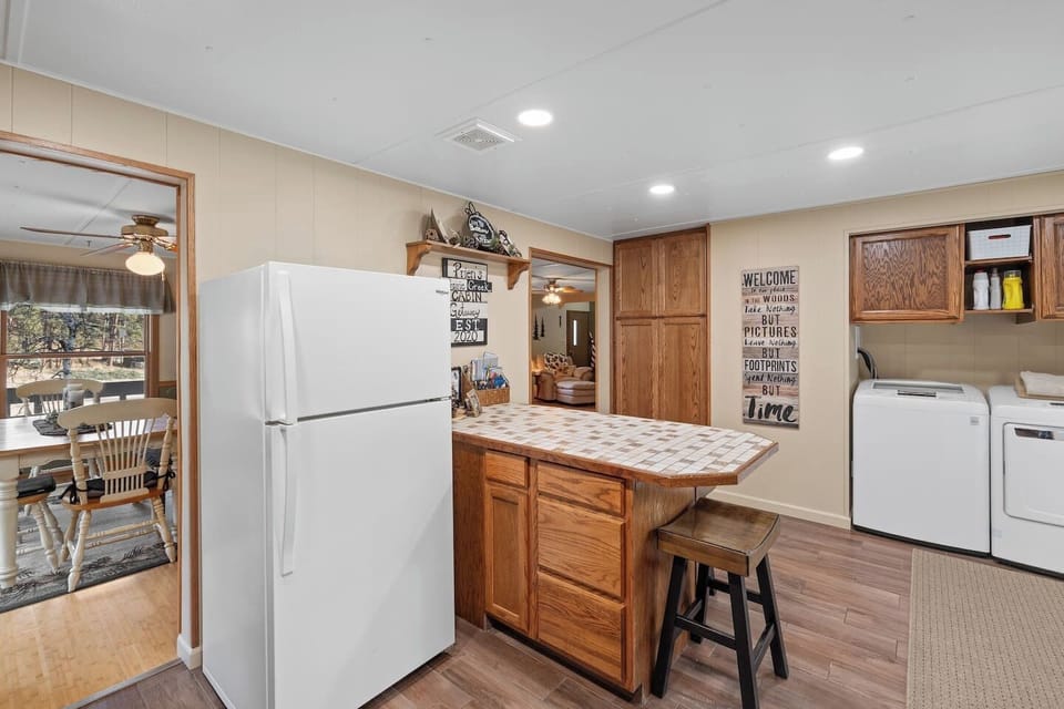 Enjoy a well-lit kitchen with recessed lighting, a casual island with barstools, and plenty of counter space.