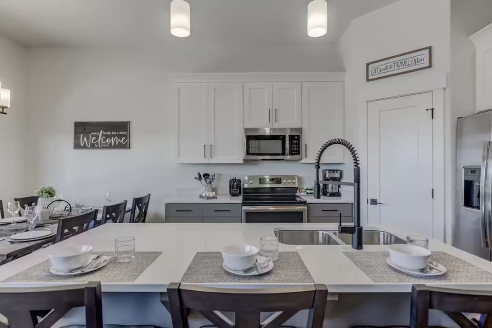 Kitchen with seating & top-of-the-line appliances and gadgets, making it the perfect space to cook and entertain.