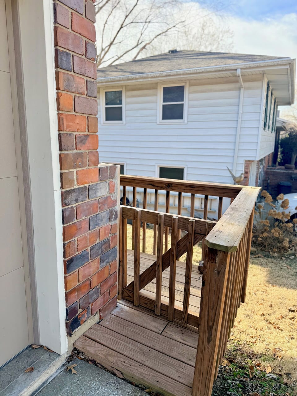 Entry gate to the right of the driveway.