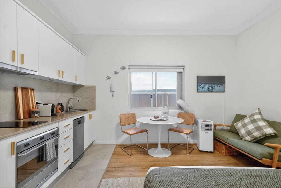 Settle in at the dining nook by the window, a light-filled spot for morning coffee, simple meals, and planning the day before heading out to the beach.