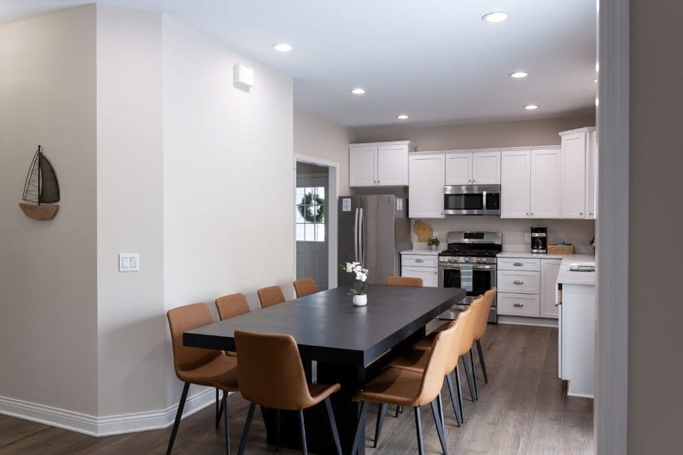 The modern kitchen and dining area create a welcoming atmosphere for families to share meals and laughter, with ample seating that enhances the home-like feel of this delightful getaway.