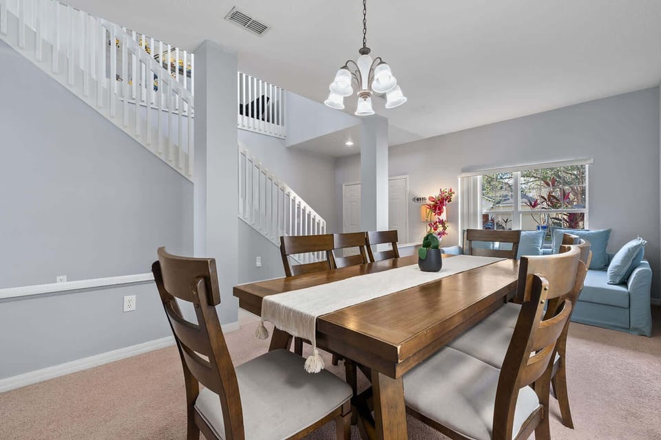 Dining area with a wooden table and natural light from a large window