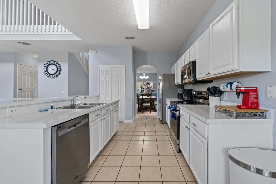 Modern kitchen with stainless steel appliances and white cabinetry