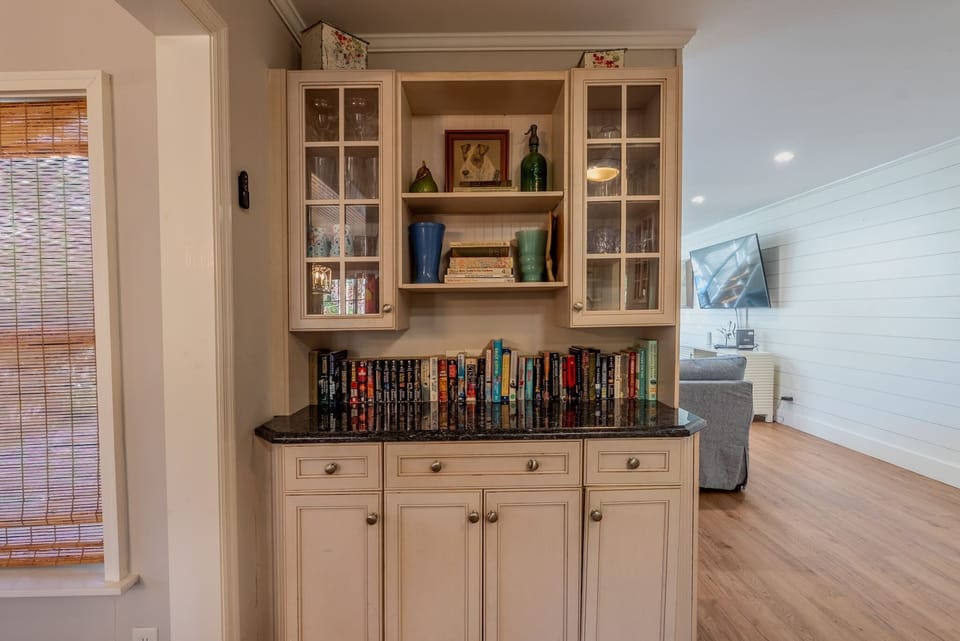 Cozy cabinet nook with books and entertainment.