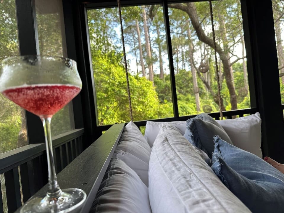 ✨Relax on the screened-in porch bed swing with lush wooded views. Perfect for sipping drinks, morning coffee, or an afternoon nap after a day at the beach. 