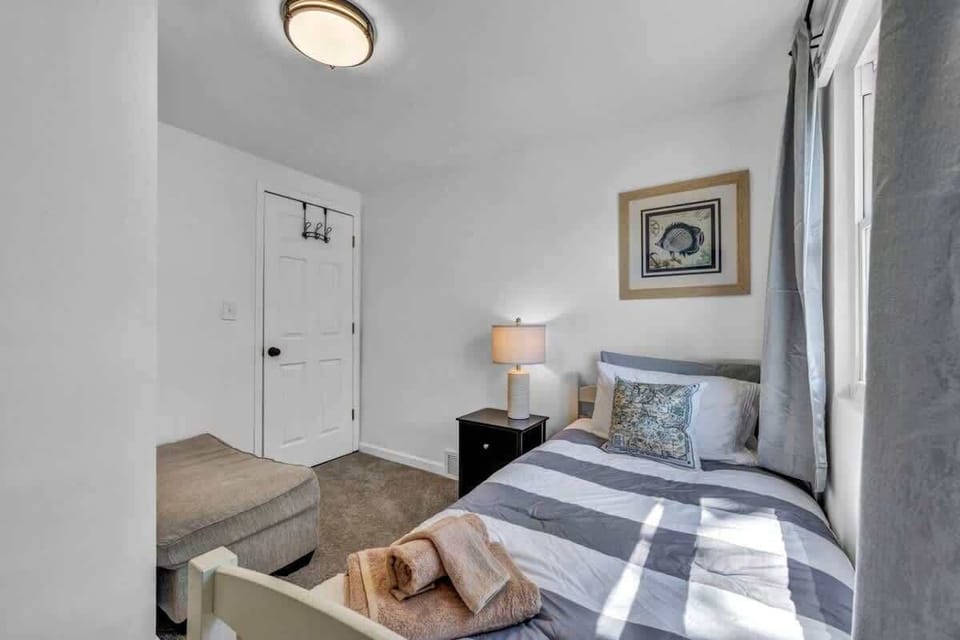 Quiet bedroom corner w/ a bed and seating area for winding down.

