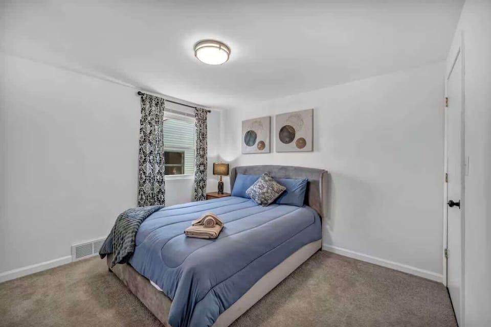 Calm bedroom w/ a cozy bed, soft lighting, and simple decor for restful nights.