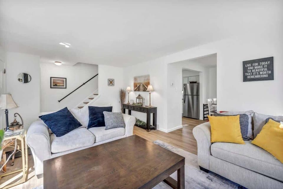Bright living room w/ comfy seating, bold accents, and an open layout that invites you to relax.
