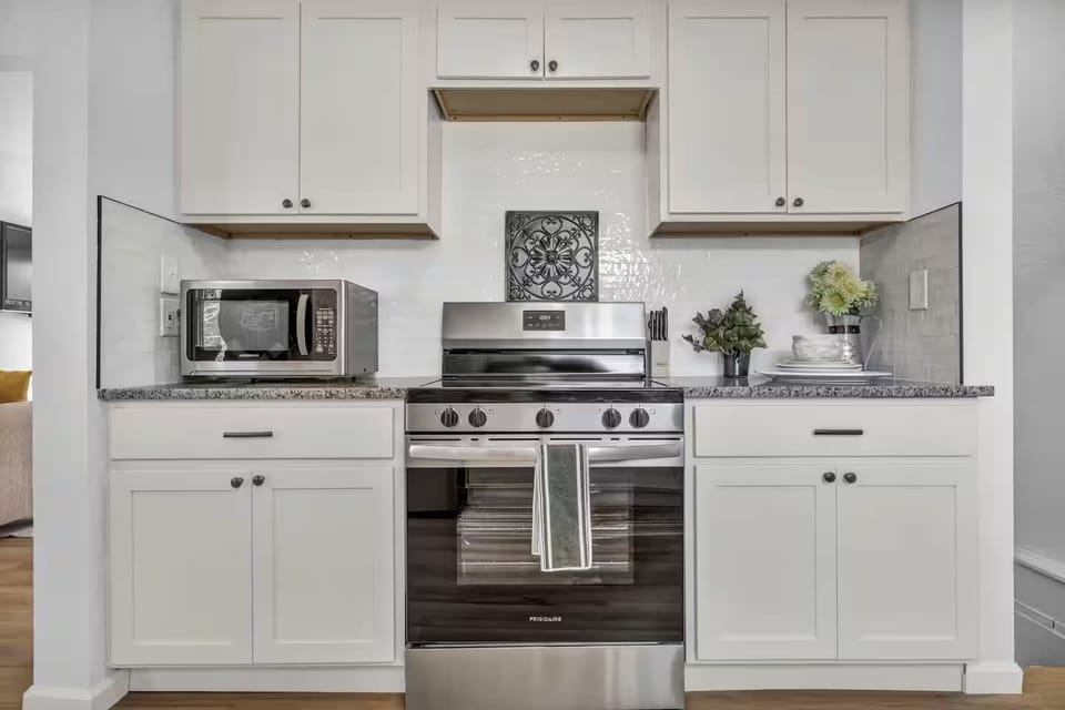 Crisp kitchen view highlighting ample storage and a practical workspace.