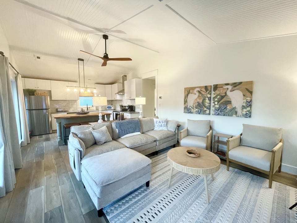 Bright, open living area with vaulted ceilings and coastal charm.