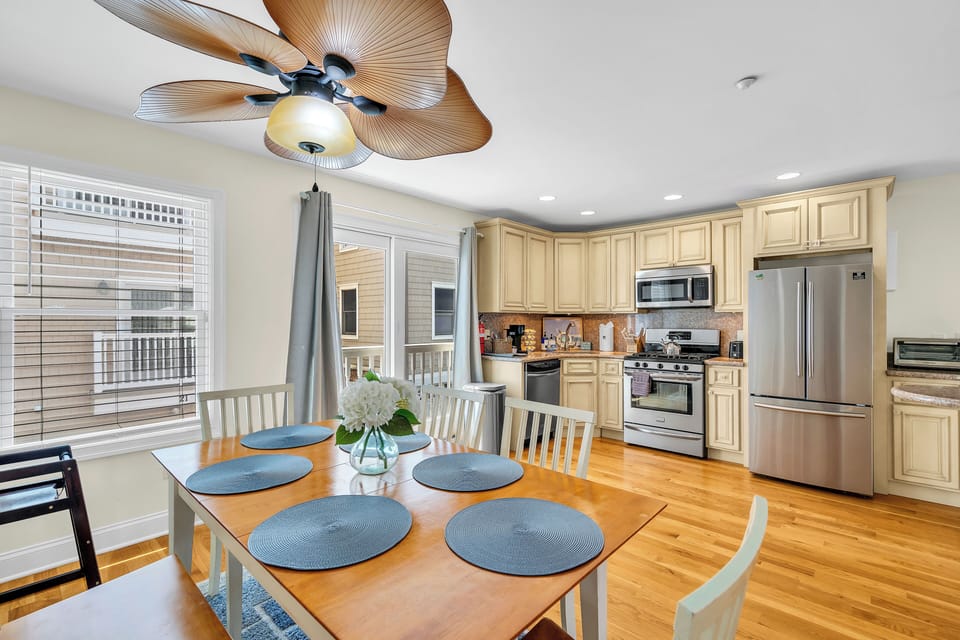 Bright open kitchen and dining area with seating for 6 and stainless appliances