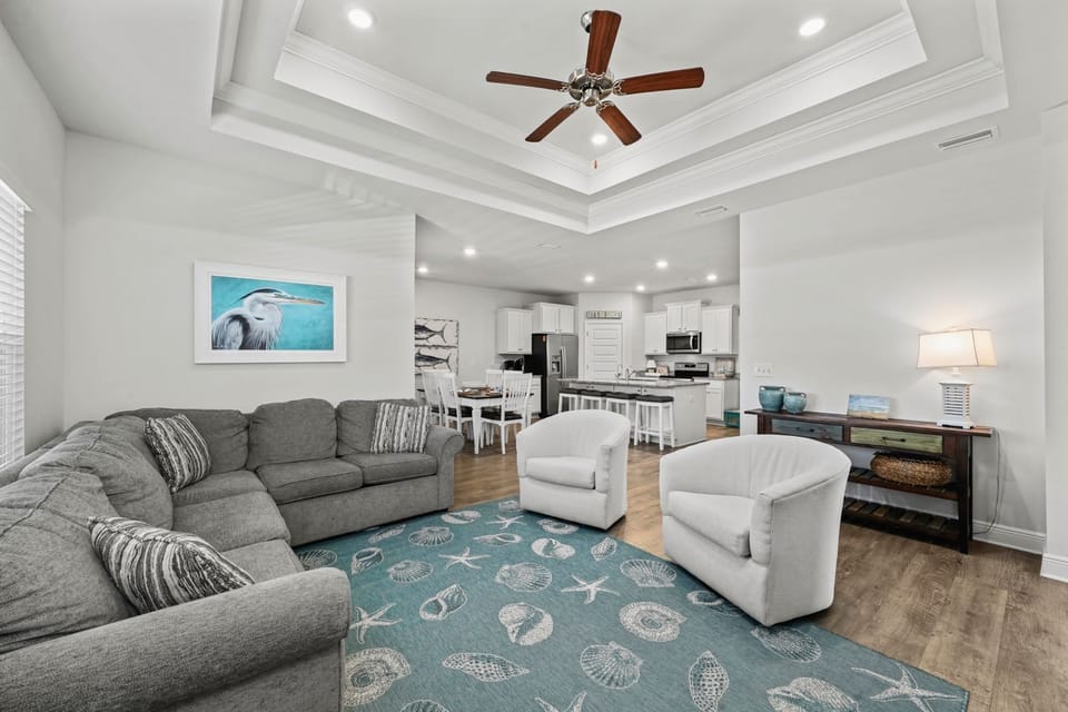 Open living space, smart tv, comfortable couches & ceiling fan
