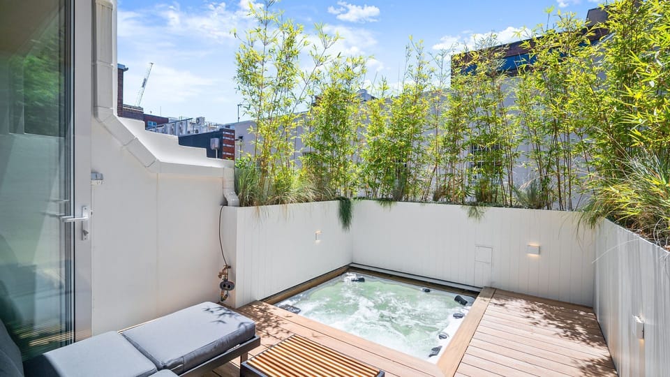 Private outdoor plunge pool surrounded by lush greenery