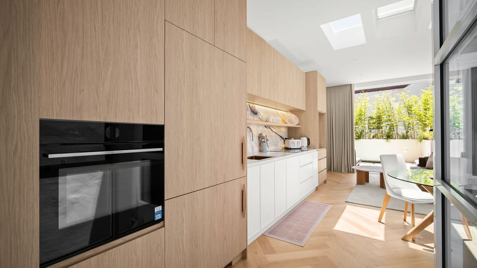 Bright modern kitchen with built-in oven and dining nook