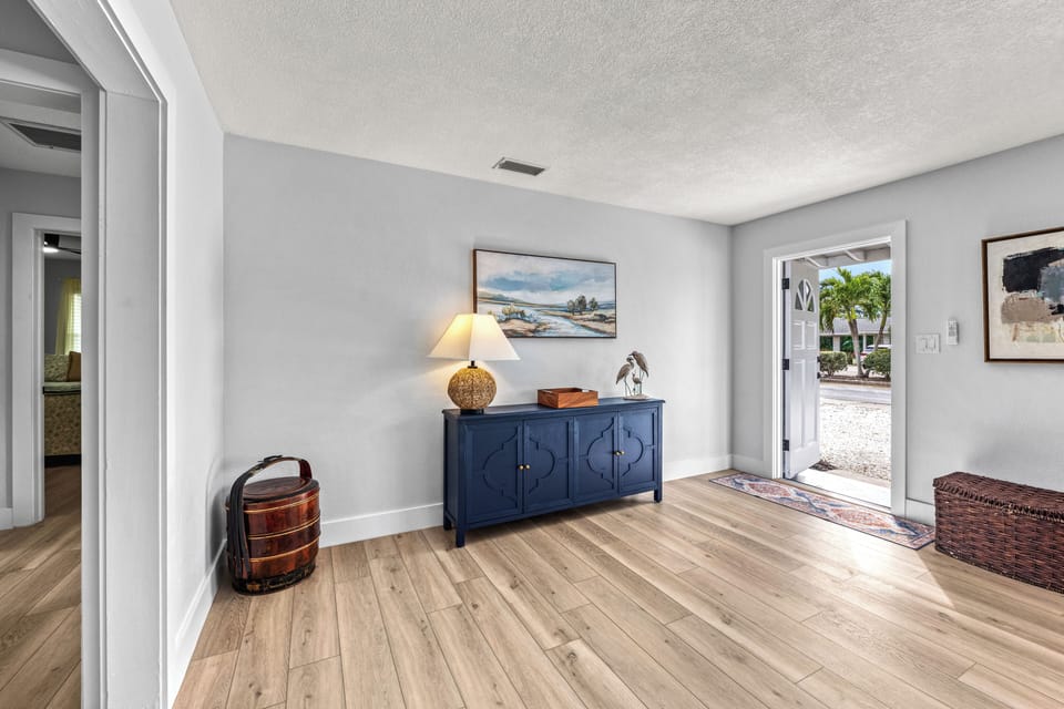 Welcoming beach-inspired foyer with the front door open to fresh ocean air.