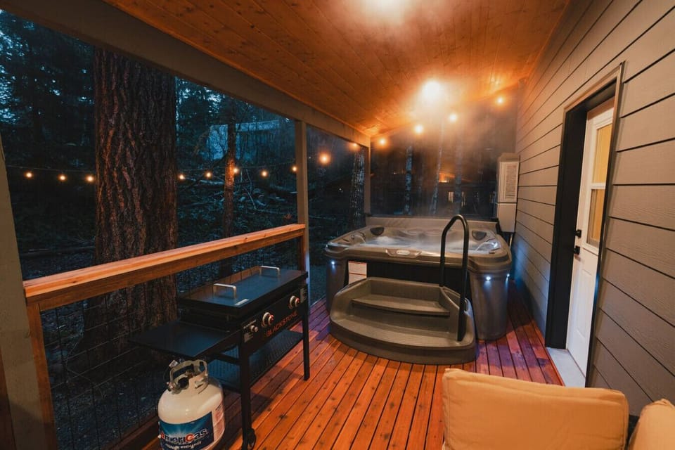 Covered Back Deck w/Lighting - Kick back with a drink, enjoy the hot tub, grill dinner, and linger long into the evening!